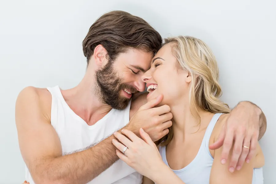 Birth-Control-Clinic A happy couple embrace in bed. Get Birth Control treatment from Christine Collins, MD in Westside/Beverly Hills.