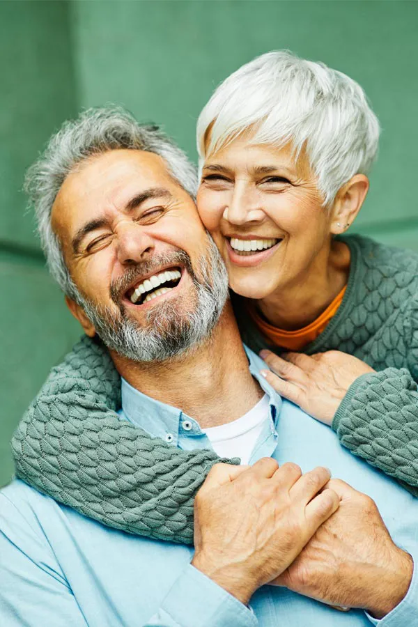 Build-Your-Own-IV-Treatment A mature couple embrace on their porch. Schedule Build Your Own IV therapy from Christine Collins, MD in Westside/Beverly Hills.