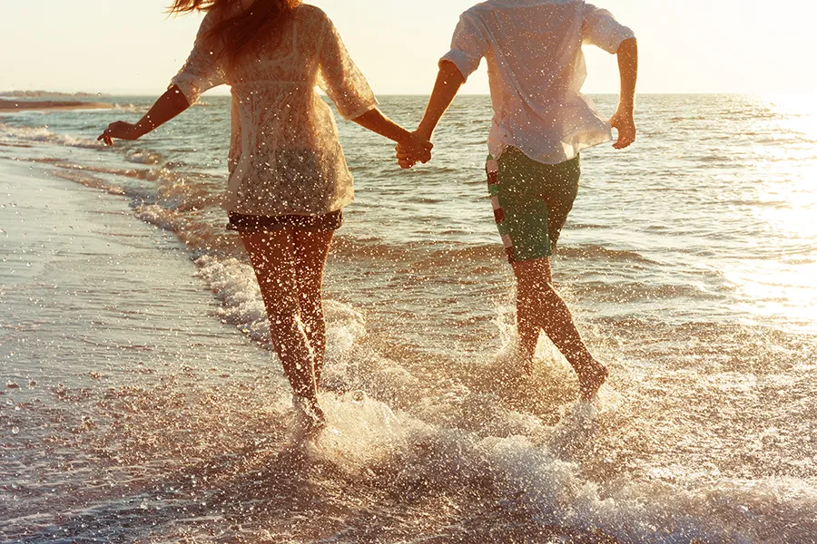 CVAC-Clinic A couple run along the shore hand in hand. Schedule CVAC therapy from Christine Collins, MD in Westside/Beverly Hills.
