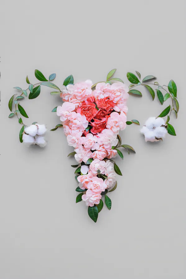 Endometriosis-Treatment Flowers on a gray background, arranged in the shape of the female reproductive system, representing Endometriosis treatment from Christine Collins, MD in Westside/Beverly Hills.