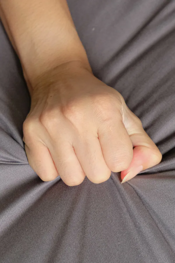 Female-Sexual-Dysfunction-Treatment Close-up of a woman's hand grabbing a sheet, indicating sexual pleasure. Get female sexual dysfunction treatment from Christine Collins, MD in Westside/Beverly Hills.