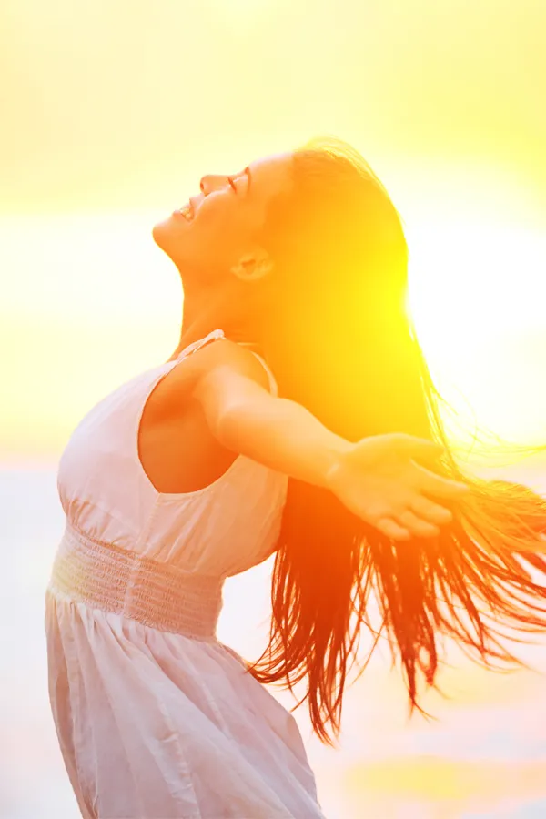 Hydration-IV-Therapy-Treatment A woman opens her arms to the sky at sunrise. Get Hydration IV Therapy from Christine Collins, MD in Westside/Beverly Hills.