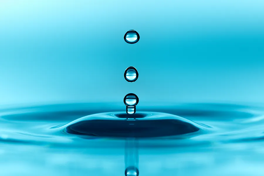 Methylene-Blue-IV-Therapy-Clinic Close-up of water dripping into a blue pool making ripples. Schedule methylene blue IV therapy from Christine Collins, MD in Westside/Beverly Hills.