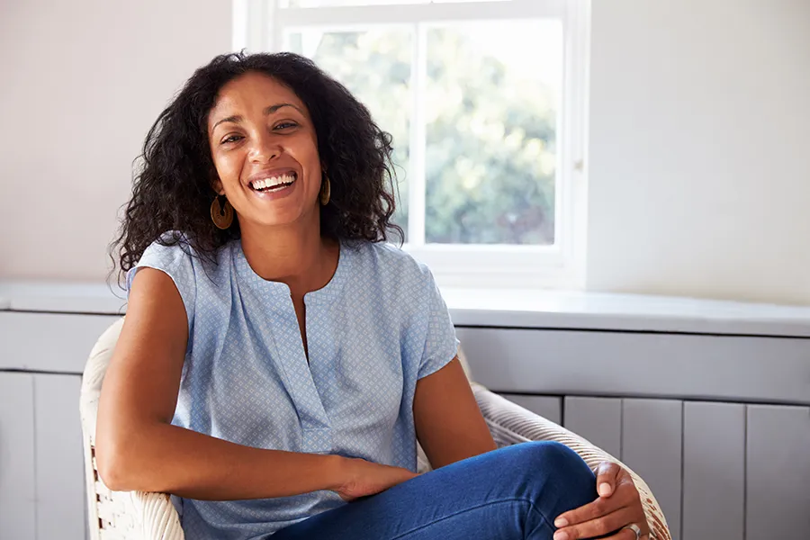 NAC-Vitamin-Injection-Clinic A happy Black woman sitting in a sun room. Get NAC Vitamin Injection treatment from Christine Collins, MD in Westside/Beverly Hills.