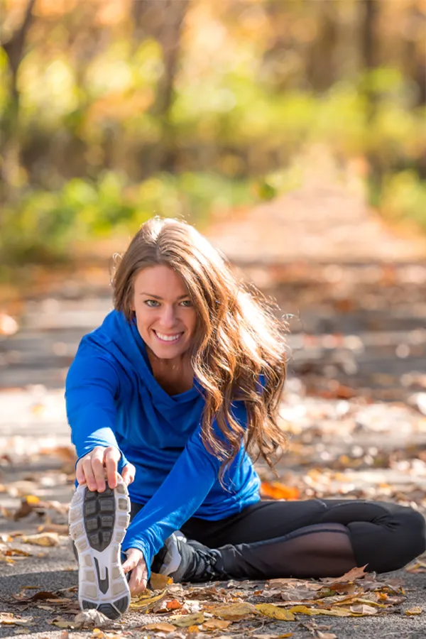 Performance-Recovery-IV-Therapy-Treatment A woman stretches before a trail run. Get IV Therapy for performance recovery relief from Christine Collins, MD in Westside/Beverly Hills.