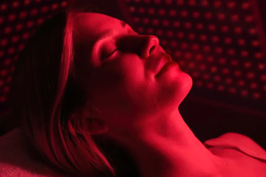 Red-Light-Therapy-Clinic A woman lies in a red light therapy device. Get red light therapy from Christine Collins, MD in Westside/Beverly Hills.