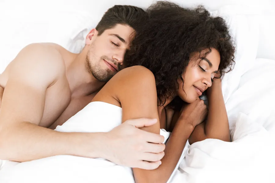 STD-Testing-Clinic A white man and black woman in bed. Get STD testing from Christine Collins, MD in Westside/Beverly Hills.