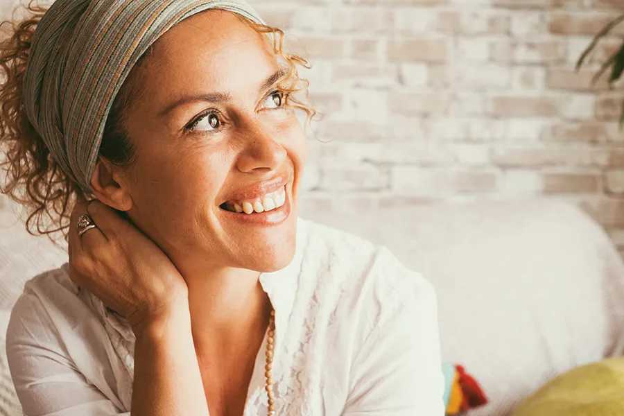 Vitamin-B6-Injection-Clinic A mixed-race woman sits smiling in her living room. Schedule Vitamin B6 Injection treatment from Christine Collins, MD in Westside/Beverly Hills.