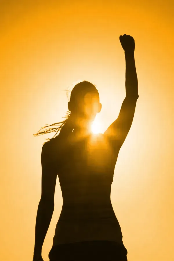 Vitamin-D3-Injection-Treatment A woman raises her hand in triumph in the sunlight. Get Vitamin D3 Injections from Christine Collins, MD in Westside/Beverly Hills.