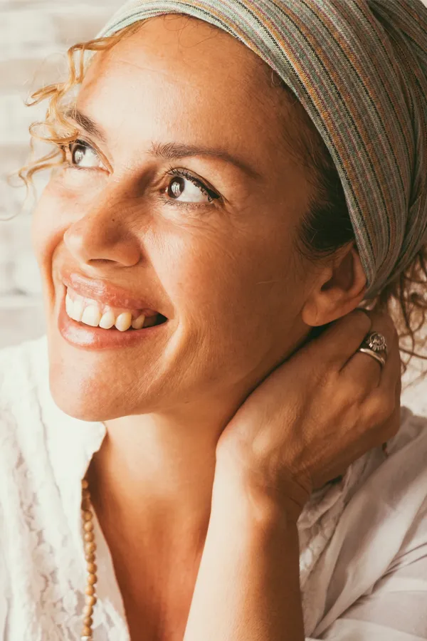 Infrared-Sauna-Doctor A woman wrapped in towels enjoying a red-lit sauna. Get infrared sauna treatment from Christine Collins, MD in Westside/Beverly Hills.